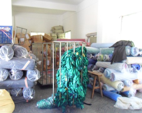 GorgeousBen warehouse with fabric rolls and organized storage showing production scale